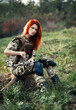 © Omeliyen - Sniper girl in a green field. Military snipers. The sniper smokes. Red-haired girl in camouflage. Fighting