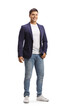 Cheerful young man in jeans and suit posing