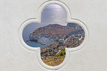 Panorama view on the historical old town Dubrovnik, through stone carved detail