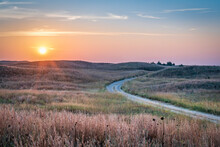 Hazy Sunrise Over Nebraska Sandhills With A Dirt Sandy Road  At Nebraska National Forest, Fall Scenery Affected By Wildfire Smoke From Colorado And Wyoming