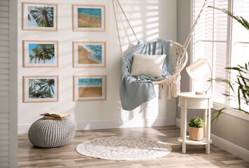 Poster - stylish room interior with artworks and hanging chair