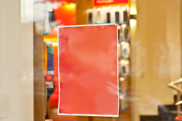 Banner for advertising in a shop window. Sign Board behind the glass. Copy space and space for text. Mockup for design. Blank template for advertising.