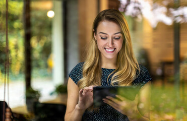 Young businesswoman using digital tablet in her office
