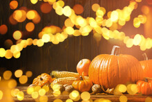 Composition With Ripe Pumpkins On Wooden Table, Bokeh Effect. Happy Thanksgiving Day