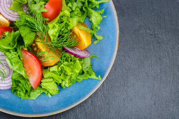 Canvas Print - Fragment of plate with vegetables and lettuce closeup, top view