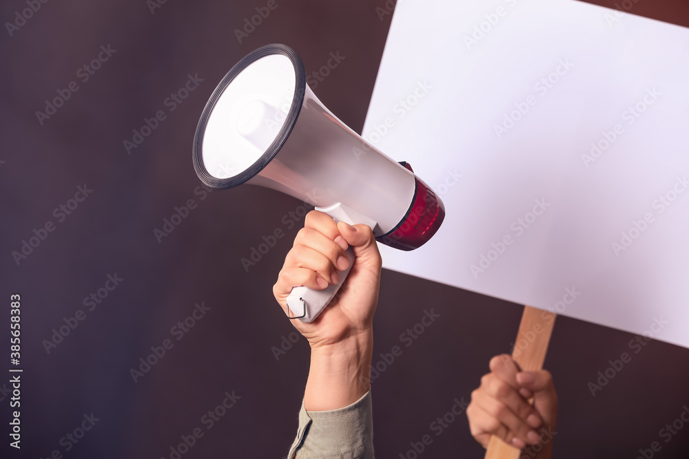 Protesting people with megaphone and placard on dark background