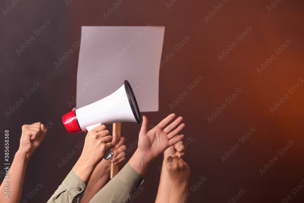 Protesting people with megaphone and placard on dark background