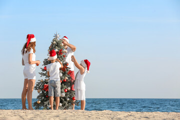 Happy family celebrating Christmas at tropical resort