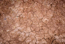 Top View Cracked Red Soil. Picture Of Natural Disaster. Drought Land, Global Warming And Deforestation. Image Of Brown Soil Texture, Close Up. Desert Realistic Background.