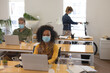© Wavebreak Media - Office colleagues wearing face masks working in office