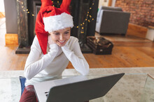 Woman In Santa Hat Having A Videocall On Laptop At Home