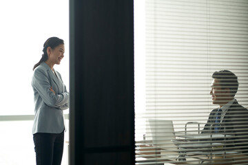 Wall Mural - asian businessman and businesswoman chatting in office