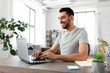 © Syda Productions - technology, remote job and business concept - man with laptop computer working at home office