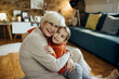 © Drazen - Loving grandmother and granddaughter embracing at home.