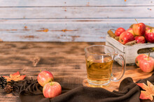 Fresh Juice With Organic Ripe Red Apples In Wooden Box. Fall Harvest Cornucopia In Autumn Season. Drink And Fruit With Wood Table Background.