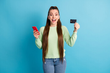 Poster - Photo portrait of screaming woman holding phone bank card isolated on pastel blue colored background