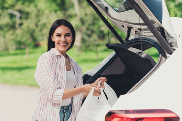 Sticker - Portrait of her she nice-looking attractive pretty careful cheerful cheery lady putting products goods in truck white car giving away belongings charity donation project summertime