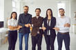 © Studio Romantic - Young office workers or startuppers standing together holding hands looking at camera