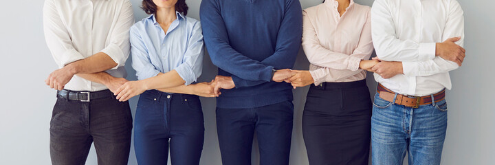 company coworkers holding hands ready to guard company interests and support each other