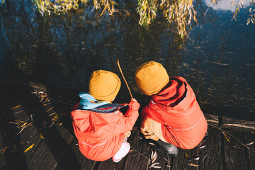 Little children spend time outside in nature.