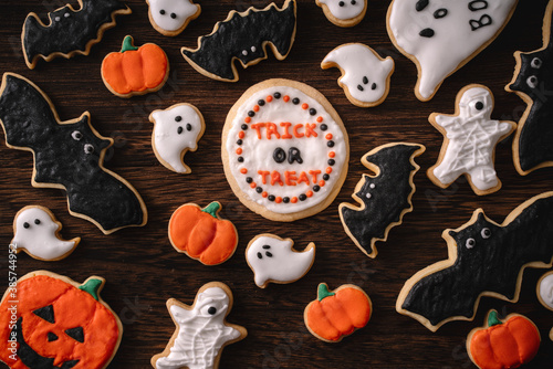 Top view of Halloween festive decorated icing gingerbread sugar cookies with copy space and flat lay layout.