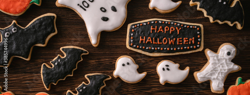 Top view of Halloween festive decorated icing gingerbread sugar cookies with copy space and flat lay layout.