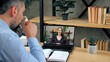 © viacheslav - Man student at home office studying online by conference video call computer, drinking coffee tea. Smiling smart woman teacher tutor trainer in laptop screen by remote web cam, distance education