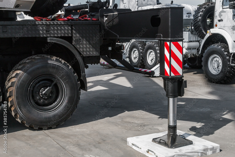 hydraulic outriggers of the crane installed on the truck. different ...
