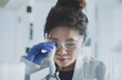 © ReeldealHD images - Female scientist looking at microscope