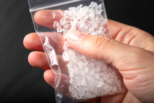 White Powder Drug In A Small Plastic Bag In Hand.