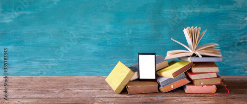 Fotografía Stack of books and an e-book reader