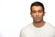 © SuperStock - Portrait of young Indian man looking at camera with straight face