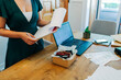 © Alexandra C. Ribeiro/Westend61 - Midsection of female professional standing with clipboard at desk in office