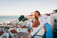Young Woman Smiling While Standing At Rooftop At Alfama, Lisbon, Portugal