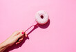 © gemma ferrando & jeremie roman/Westend61 - Hand of woman holding fork with sweet doughnut