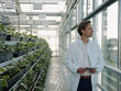 © Joseffson/Westend61 - Scientist holding tablet in a greenhouse looking out of window