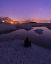 Germany, Bavaria, Silhouette Of Hooded Man Admiring Forggensee Lake At Purple Night