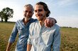 © KNSY/Westend61 - Portrait of happy father with adult son on a meadow in the countryside