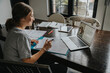 © Mareen Fischinger/Westend61 - Teenage girl studying from home, using laptop