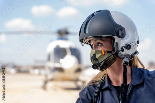 Fotografie, Obraz Female police pilot looking away while wearing protective face mask