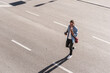 © UWE_UMSTAETTER/Westend61 - Smiling man talking on mobile phone while crossing street in city