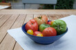Garden vegetables in a bowl on a wooden table 