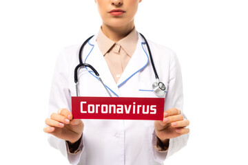 Wall Mural - Cropped view of doctor holding card with coronavirus lettering isolated on white