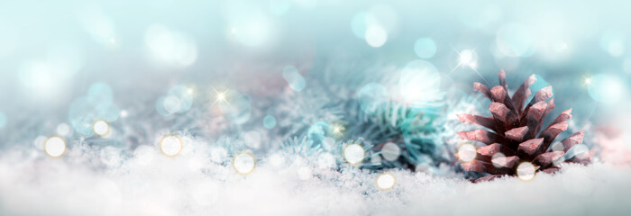 Christmas background with fir tree cone and snow.Glitter vintage lights background.