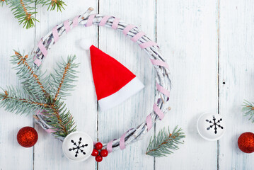 Wall Mural - Santa hat and pine tree branches on old wood table, Christmas background