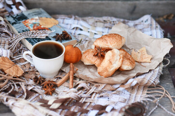 Fresh croissants with cream and hot coffee. Autumn composition.