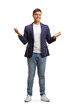 Full length portrait of a happy young man in jeans and suit gesturing with hands