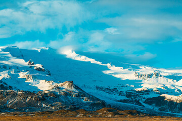 Wall Mural - Incredible Icelandic landscapes. Snow-capped mountains and glacier. Sunset.