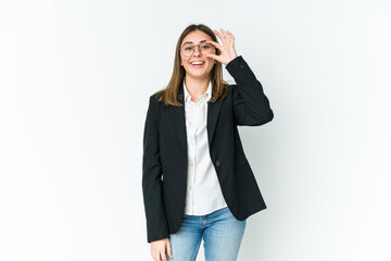 Young caucasian business woman excited keeping ok gesture on eye.