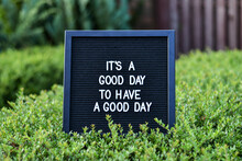 "Its A Good Day To Have A Good Day" Words Written On A Black Letterbox At The Outdoor Terace. Blurred Background.